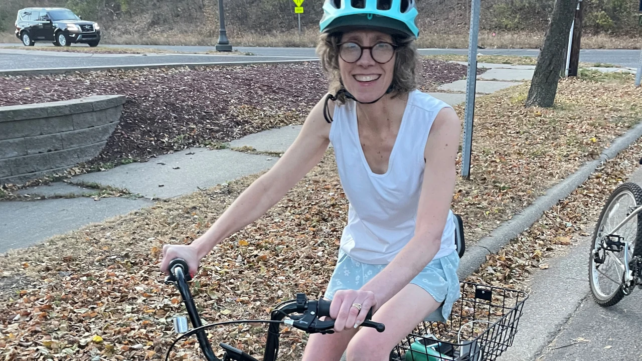 Woman wearing a helmut riding an electric bike