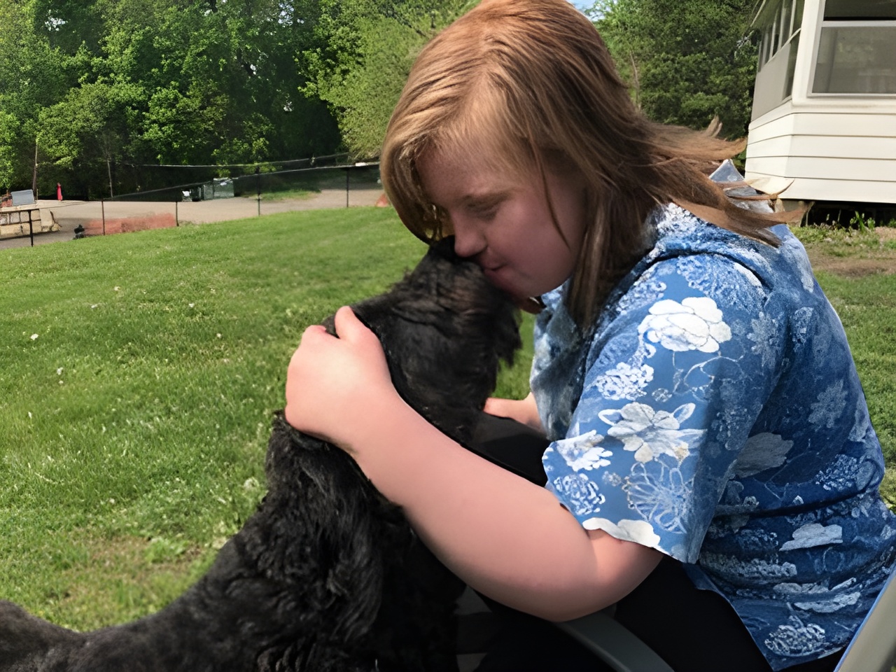 Accra client Katie pets her neighbor's dog named Olive